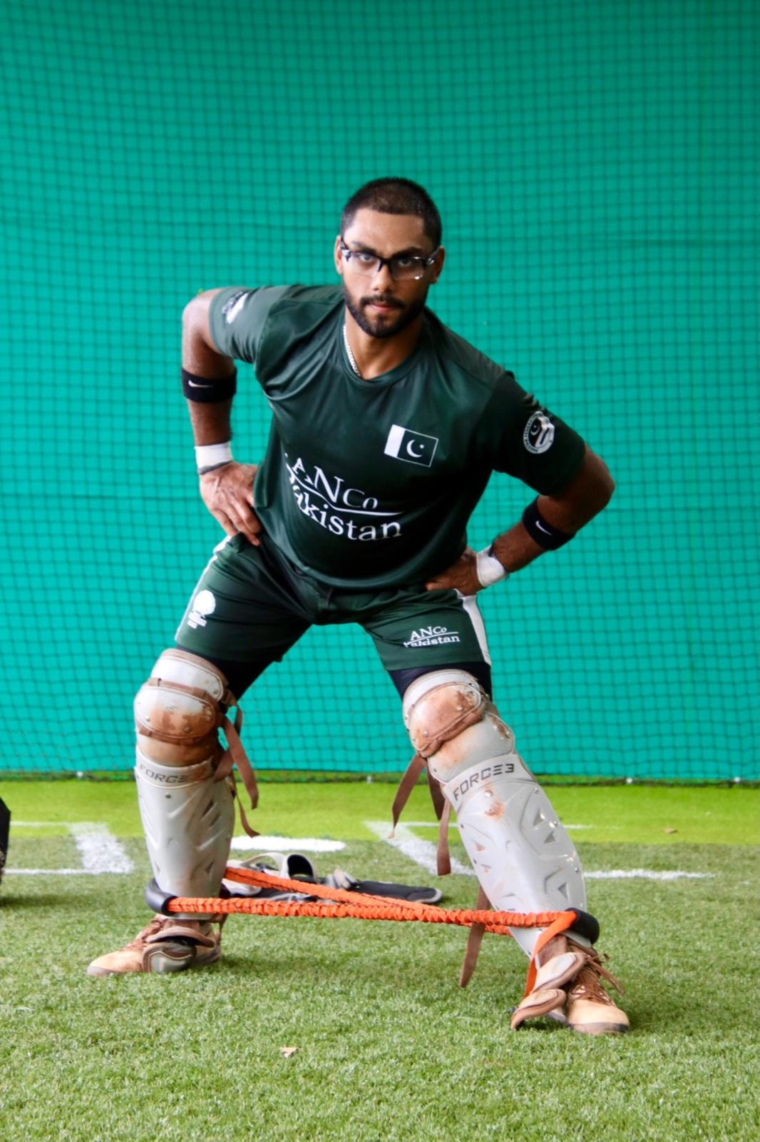 Pakistan catcher in training gear with shin guards