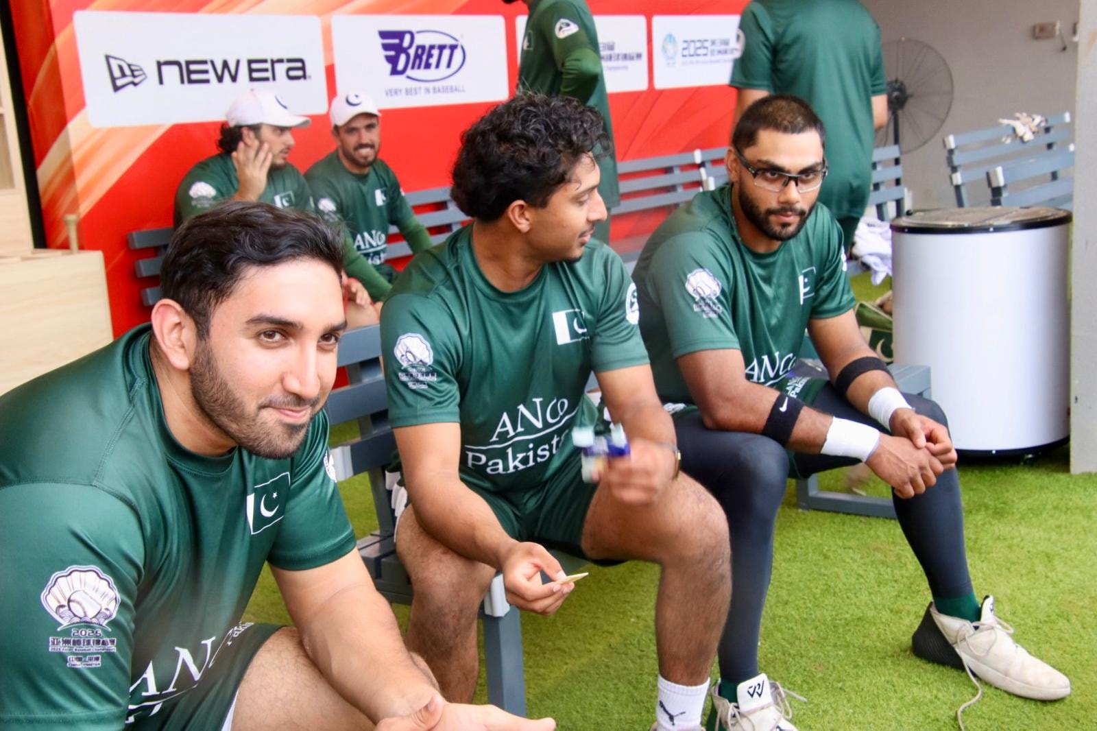 Pakistan team in the dugout in green uniforms